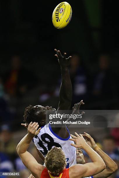 Majak Daw of the Kangaroos contests for the ball during the round seven AFL match between the North Melbourne Kangaroos and the Gold Coast Suns at...
