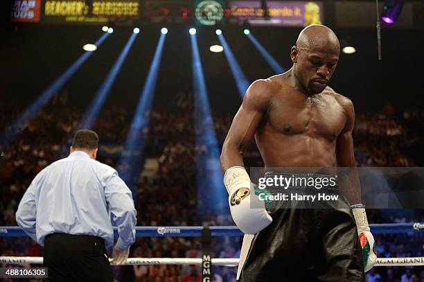 Floyd Mayweather Jr. Looks down while taking on Marcos Maidana during their WBC/WBA welterweight unification fight at the MGM Grand Garden Arena on...