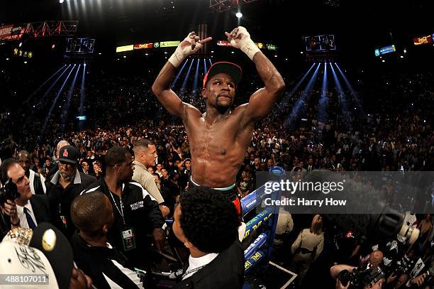 Floyd Mayweather Jr. Celebrates after defeating Marcos Maidana by majority decision in their WBC/WBA welterweight unification fight at the MGM Grand...