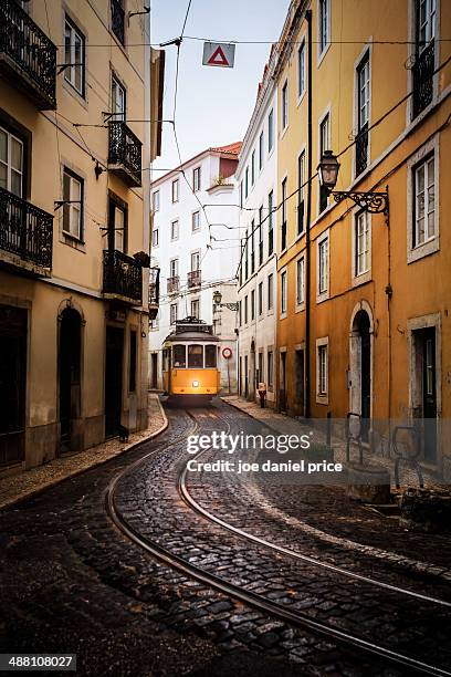 yellow tram, alfama district - alfama lisbon stock pictures, royalty-free photos & images