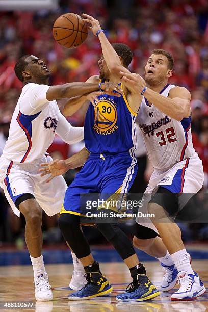 Stephen Curry of the Golden State Warriors tries to pass the ball between Chris Paul and Blake Griffin of the Los Angeles Clippers in Game Seven of...