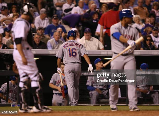 Daisuke Matsuzaka of the New York Mets returns to the dugout after striking out bunting against relief pitcher Rex Brothers of the Colorado Rockies...