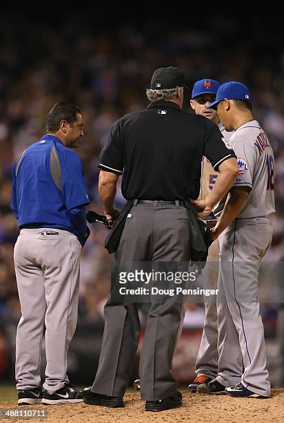 The trainer visits the mound to check on Daisuke Matsuzaka of the New York Mets as he works against the Colorado Rockies at Coors Field on May 3,...