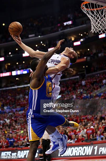 Blake Griffin of the Los Angeles Clippers makes a basket and is fouled by Harrison Barnes of the Golden State Warriors in Game Seven of the Western...