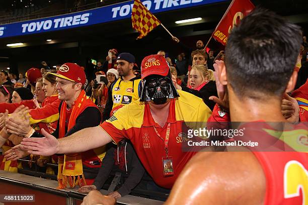 Suns fan with a Darth Vader mask celebrates the win during the round seven AFL match between the North Melbourne Kangaroos and the Gold Coast Suns at...