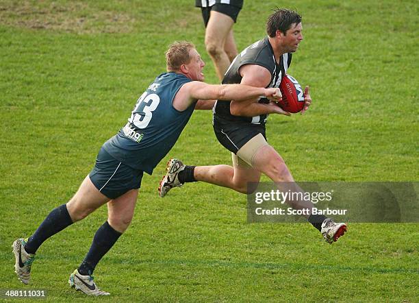 Leigh Brown of the Pies Legends marks the ball in front of Dean Rice of the Navy Blues during the match between the Navy Blues and the Pies Legends...