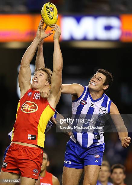 Tom Lynch of the Suns marks the ball against Nathan Grima of the Kangaroos during the round seven AFL match between the North Melbourne Kangaroos and...