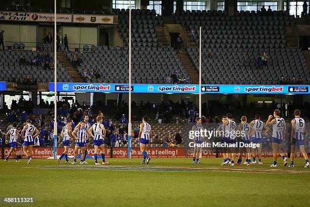 Kangaroos players look on after their defeat during the round seven AFL match between the North Melbourne Kangaroos and the Gold Coast Suns at Etihad...