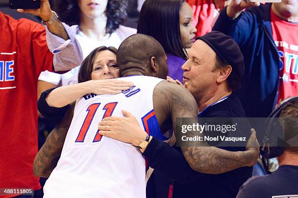 Billy Crystal and Janice Crystal hug Jamal Crawford at an NBA playoff game between the Golden State Warriors and the Los Angeles Clippers at Staples...