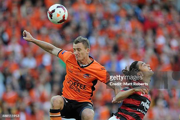 Besart Berisha of the Roar heads the ball towards the goal over Jerome Polenz of the Wanderers during the 2014 A-League Grand Final match between the...