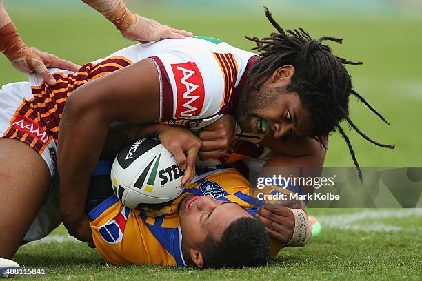 Jamal Idris of Country tackles Dylan Walker of City during the Origin match between City and Country at Caltex Park on May 4, 2014 in Dubbo,...