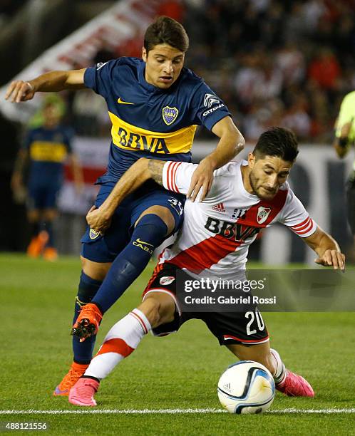 Sebastian Palacios of Boca Juniors fights for the ball with Milton Casco of River Plate during a match between River Plate and Boca Juniors as part...