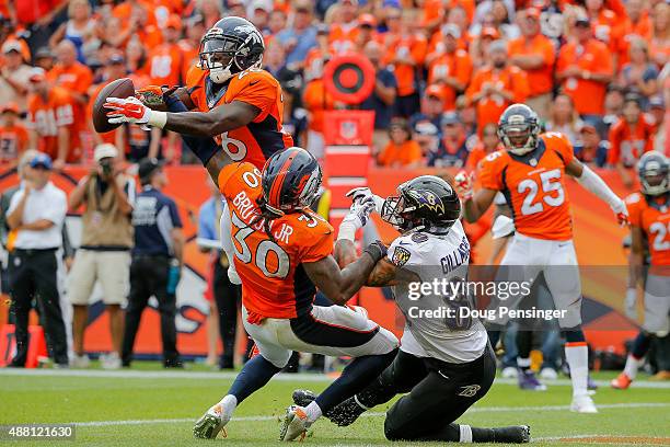 Defensive back Darian Stewart of the Denver Broncos makes a game-ending interception in the end zone of a pass intended for tight end Crockett...