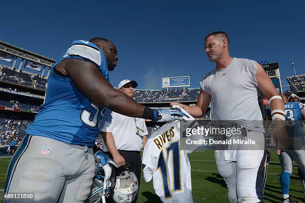 Middle linebacker Stephen Tulloch of the Detroit Lions and quarterback Philip Rivers of the San Diego Chargers shake hands after the Chargers...