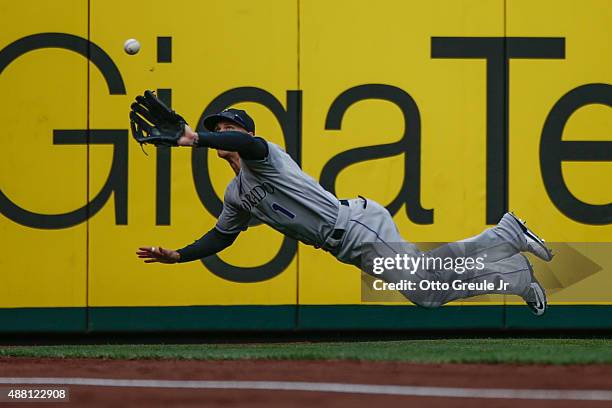 Left fielder Brandon Barnes of the Colorado Rockies makes a diving catch on a ball off the bat of Kyle Seager of the Seattle Mariners in the eighth...