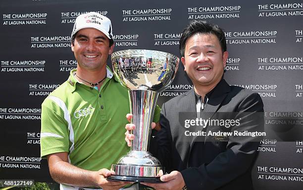 Felipe Aguilar of Chile receives the trophy from Kevin Kwee, Executive Director of Laguna National, after winning The Championship at Laguna National...
