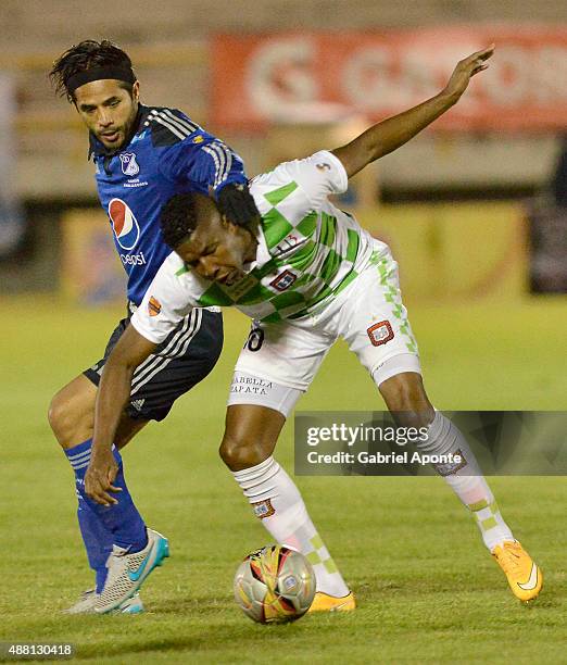 Fabian Vargas of Millonarios struggles for the ball with Francisco Rodriguez of Boyaca Chico during a match between Boyaca Chico and Millonarios as...