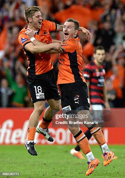 Luke Brattan and Besart Berisha of the Roar celebrate victory as the full time siren sounds the 2014 A-League Grand Final match between the Brisbane...