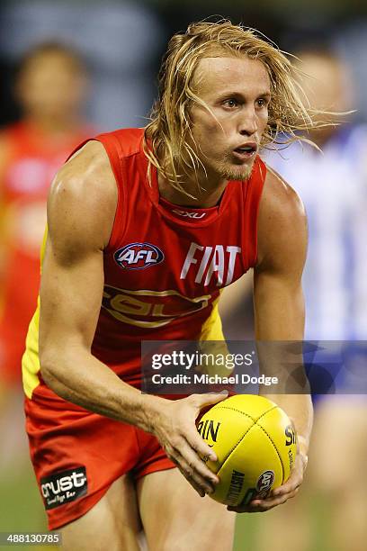 Matt Shaw looks ahead with the ball during the round seven AFL match between the North Melbourne Kangaroos and the Gold Coast Suns at Etihad Stadium...