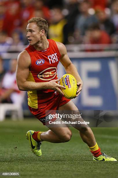 Brandon Matera of the Suns looks ahead with the ball during the round seven AFL match between the North Melbourne Kangaroos and the Gold Coast Suns...