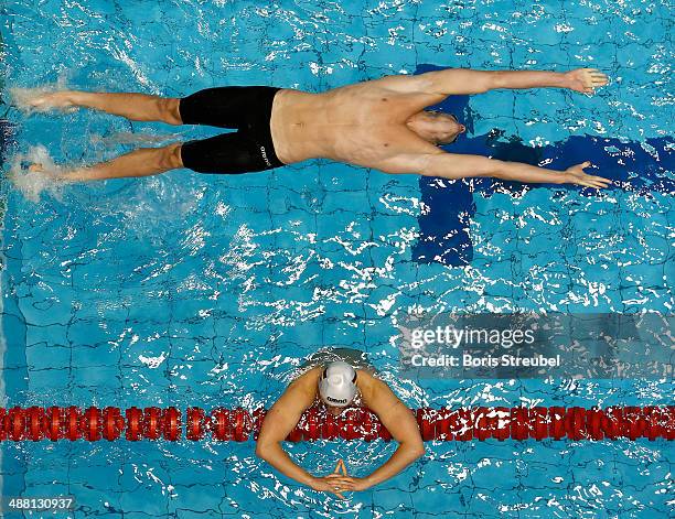 Nicolas Graesser of Deutscher Schwimm-Verband takes the start of the men's 100 m backstroke heat during day three of the German Swimming Championship...
