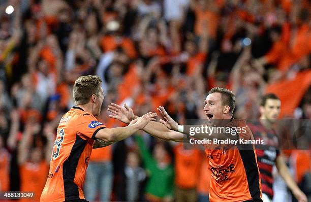 Luke Brattan and Besart Berisha of the Roar celebrate victory as the full time siren sounds the 2014 A-League Grand Final match between the Brisbane...