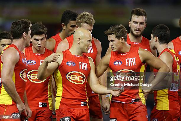 Gary Ablett of the Suns gestures to David Swallow during the round seven AFL match between the North Melbourne Kangaroos and the Gold Coast Suns at...