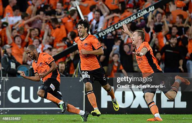 Henrique of the Roar celebrates scoring a goal in extra time as team mates Thomas Broich and Besart Berisha are seen celebrating during the 2014...