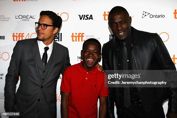 Director / Writer Cary Fukunaga, actor Abraham Attah, and actor Idris Elba attend the "Beasts Of No Nation" premiere during the 2015 Toronto...