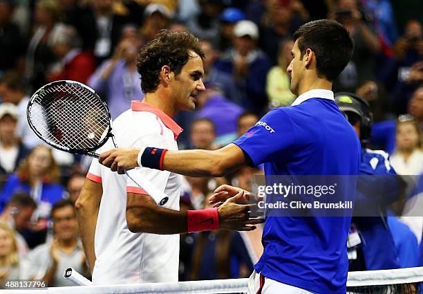 Novak Djokovic of Serbia shakes hand with Roger Federer of Switzerland after their Men's Singles Final match on Day Fourteen of the 2015 US Open at...
