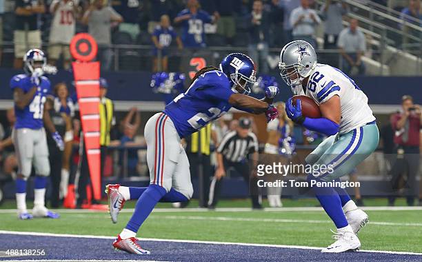 Jason Witten of the Dallas Cowboys scores the game tying touchdown against Brandon Meriweather of the New York Giants at AT&T Stadium on September...
