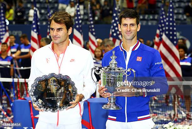 Novak Djokovic of Serbia, right, and Roger Federer of Switzerland celebrate with their trophies after their Men's Singles Final match on Day Fourteen...
