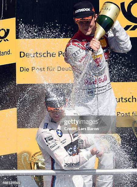 First placed Marco Wittmann of Germany and BMW Team RMG celebrates with second placed Mattias Ekstroem of Sweden and Audi Sport Team Abt Sportsline...