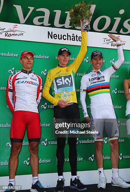 Chris Froome of Great Britain and Team Sky celebrates claiming the overall race victory and yellow jersey alongside second placed Simon Spilak of...