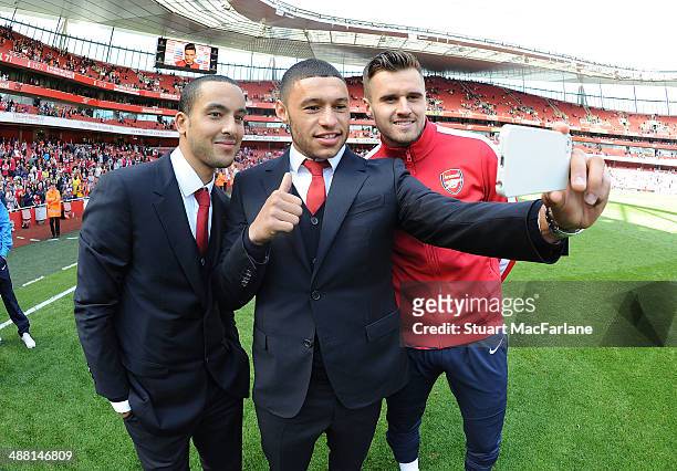 Theo Walcott, Alex Oxlade-Chamberain and Carl Jenkinson of Arsenal after the Barclays Premier League match between Arsenal and West Bromwich Albion...