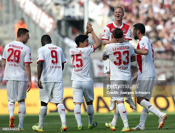 Sascha Bigalke of Cologne is carried by Matthias Lehmann after scoring the fourth goal during the Second Bundesliga match between 1. FC Koeln and FC...