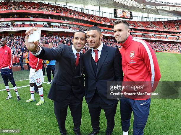 Theo Walcott, Alex Oxlade-Chamberain and Carl Jenkinson of Arsenal after the Barclays Premier League match between Arsenal and West Bromwich Albion...