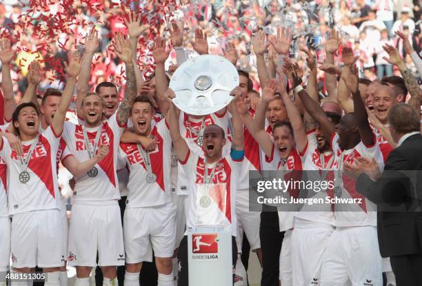 Team captain Miso Brecko of Cologne lifts the trophy after winning the championship title of the Second Bundesliga at RheinEnergieStadion on May 4,...