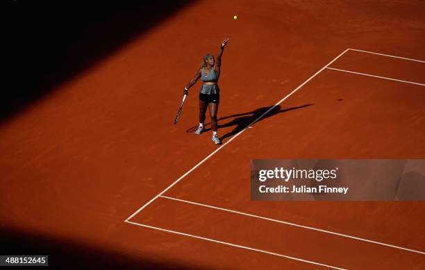 Serena Williams of USA serves to Belinda Bencic of Switzerland during day two of the Mutua Madrid Open tennis tournament at the Caja Magica on May 4,...