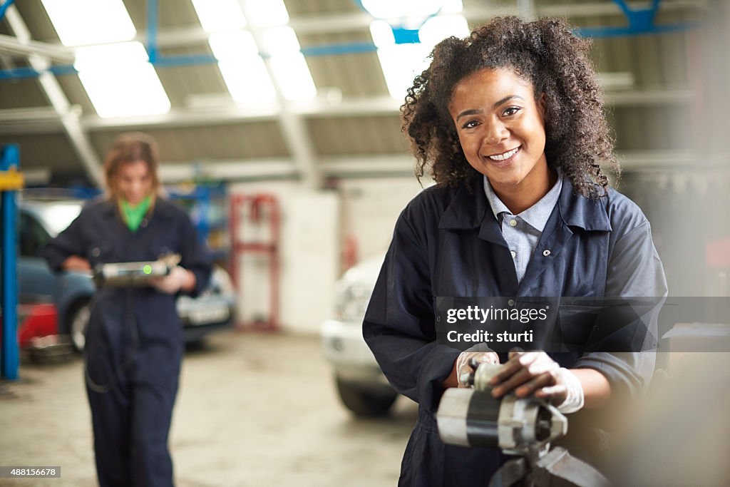 Happy female auto mechanic