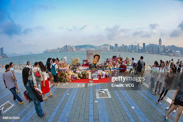 Fans present flowers and posters to mourn singer and actor Leslie Cheung at Avenue of Stars on September 13, 2015 in Hong Kong. Cheung died aged 46...