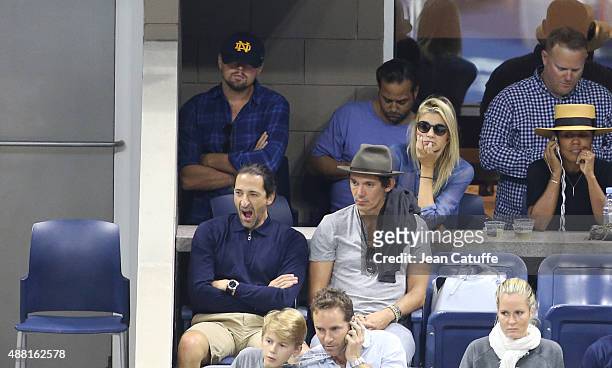 Leonardo DiCaprio and girlfriend Kelly Rohrbach, below them Adrien Brody and Lukas Haas attend the Men's Final on day fourteen of the 2015 US Open at...