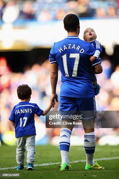 Eden Hazard of Chelsea and his family appear on the pitch following the Barclays Premier League match between Chelsea and Norwich City at Stamford...