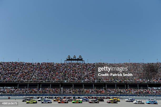 Brian Scott, driver of the Shore Lodge Chevrolet, and Paul Menard, driver of the Richmond / Menard's Chevrolet, lead the field to the start of the...