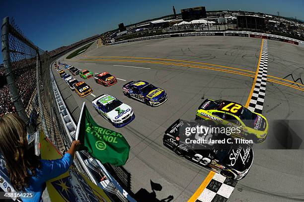 Brian Scott, driver of the Shore Lodge Chevrolet, and Paul Menard, driver of the Richmond / Menard's Chevrolet, lead the field to start the NASCAR...