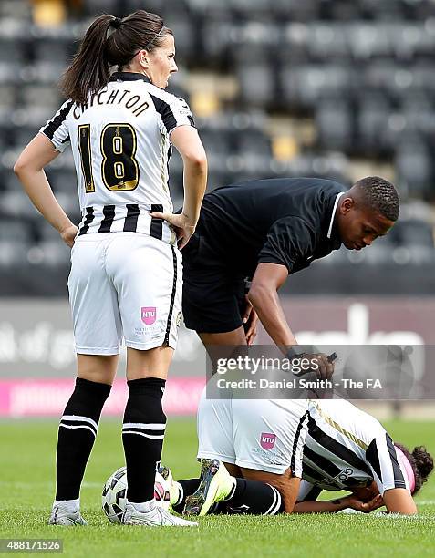 The referee cheks on Desiree Scott of Notts Ladies County FC after being hit in the face with the ball during the FA WSL Continental Tyres Cup...