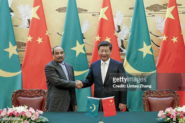 Chinese President Xi Jinping shankes hands with Mauritania's President Mohamed Ould Abdel Aziz during the signing ceremony at the Great Hall of the...