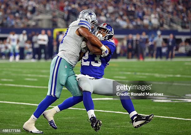 Rashad Jennings of the New York Giants is tackled by Kyle Wilber of the Dallas Cowboys at AT&T Stadium on September 13, 2015 in Arlington, Texas.