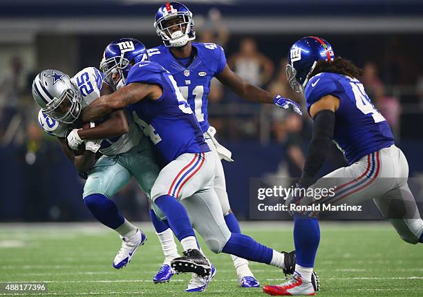 Lance Dunbar of the Dallas Cowboys runs the ball against Jasper Brinkley of the New York Giants at AT&T Stadium on September 13, 2015 in Arlington,...