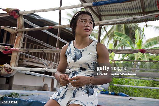 Rose changes into a dress after a workout session at the small Muay Thai gym in front of her home on September 14, 2015 in Phimai, Thailand. Somros...